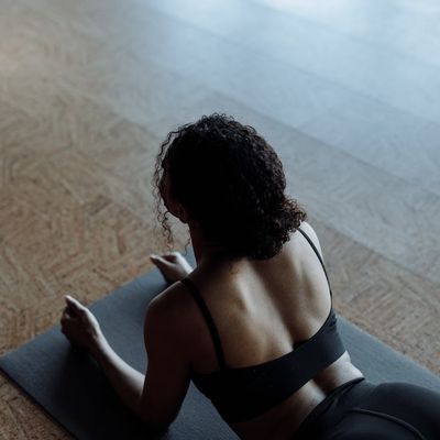 An empty, clean yoga mat on a dark floor.